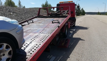 Flatbed tow truck prepared for vehicle towing and transport.